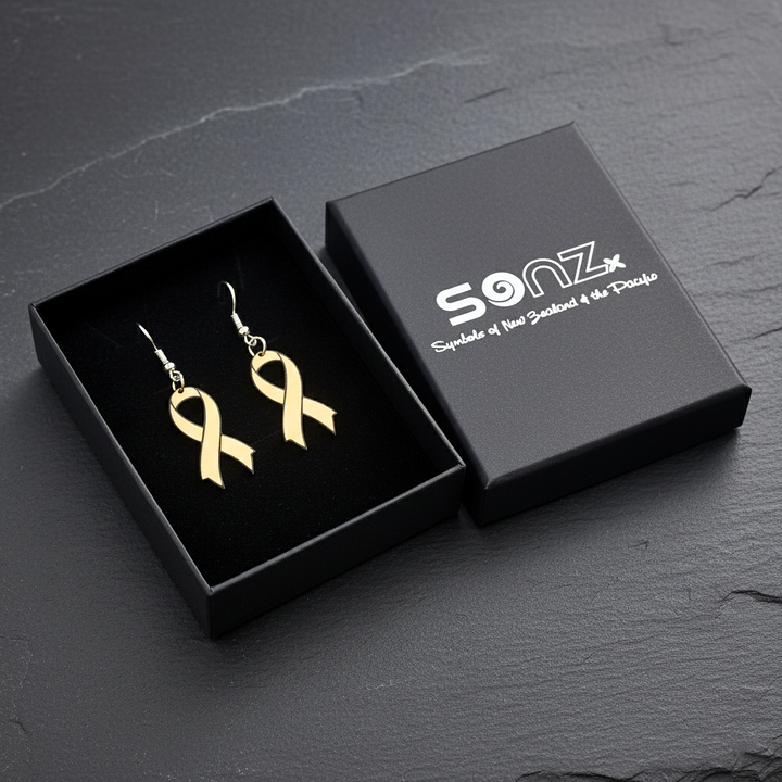Product photo of Hugo’s Ribbon gold awareness earrings displayed in a black SoNZ gift box on a dark slate surface.