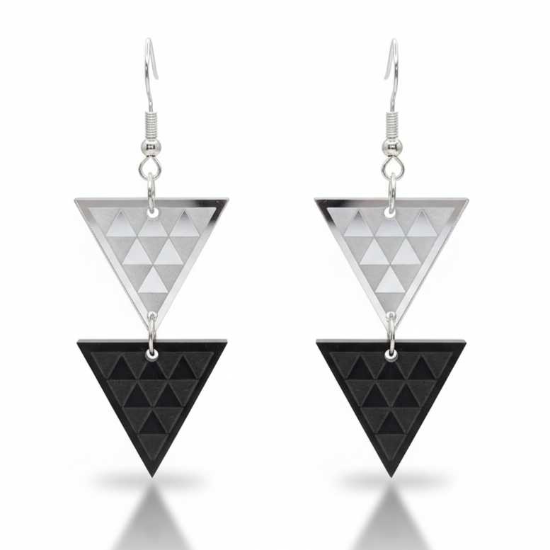 Tāniko Double earrings, stacked triangles with tāniko pattern in silver mirror acrylic with black acrylic.