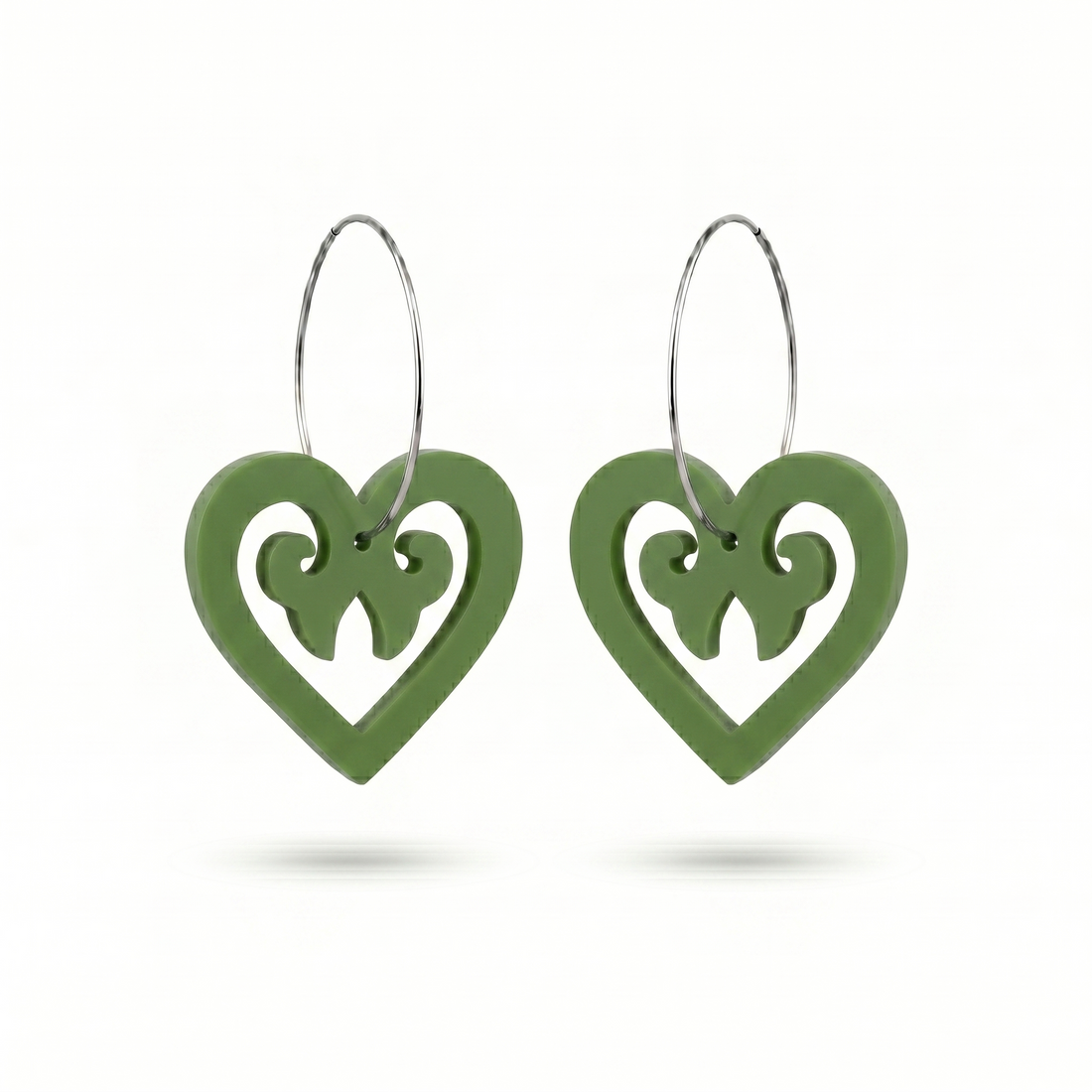 Aroha Heart Open earrings, open heart with koru scrollwork on a silver hoop in pounamu satin.