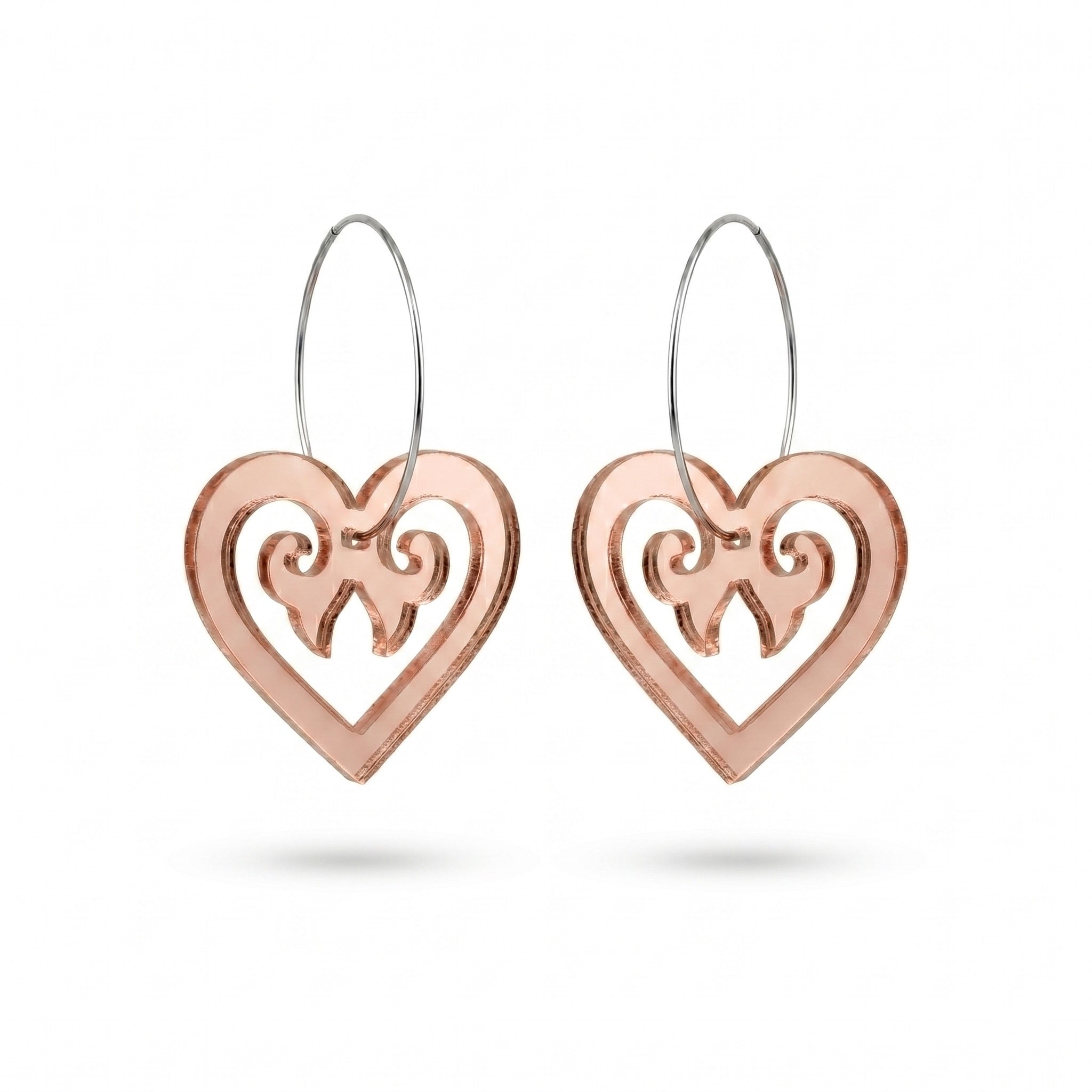 Aroha Heart Open earrings, open heart with koru scrollwork on a silver hoop in rose-gold mirror.