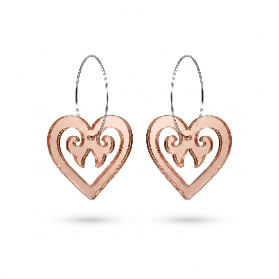 Aroha Heart Open earrings, open heart with koru scrollwork on a silver hoop in rose-gold mirror.