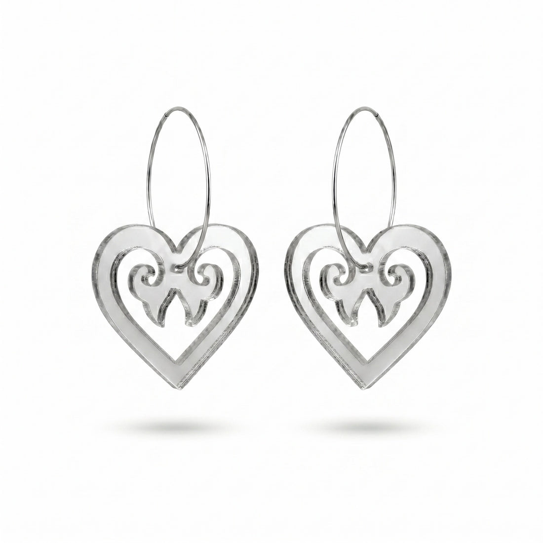 Aroha Heart Open earrings, open heart with koru scrollwork on a silver hoop in silver mirror.
