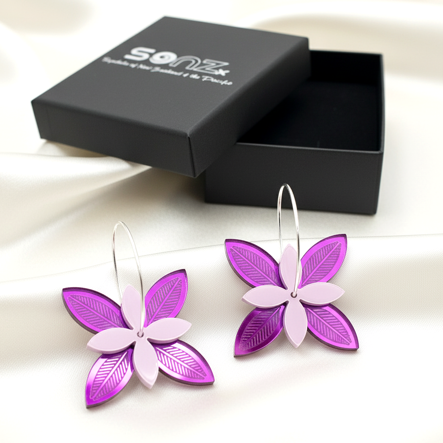 Frangipani Lines Spinner earrings in SoNZ gift box; purple on fuchsia acrylic with engraved lines.