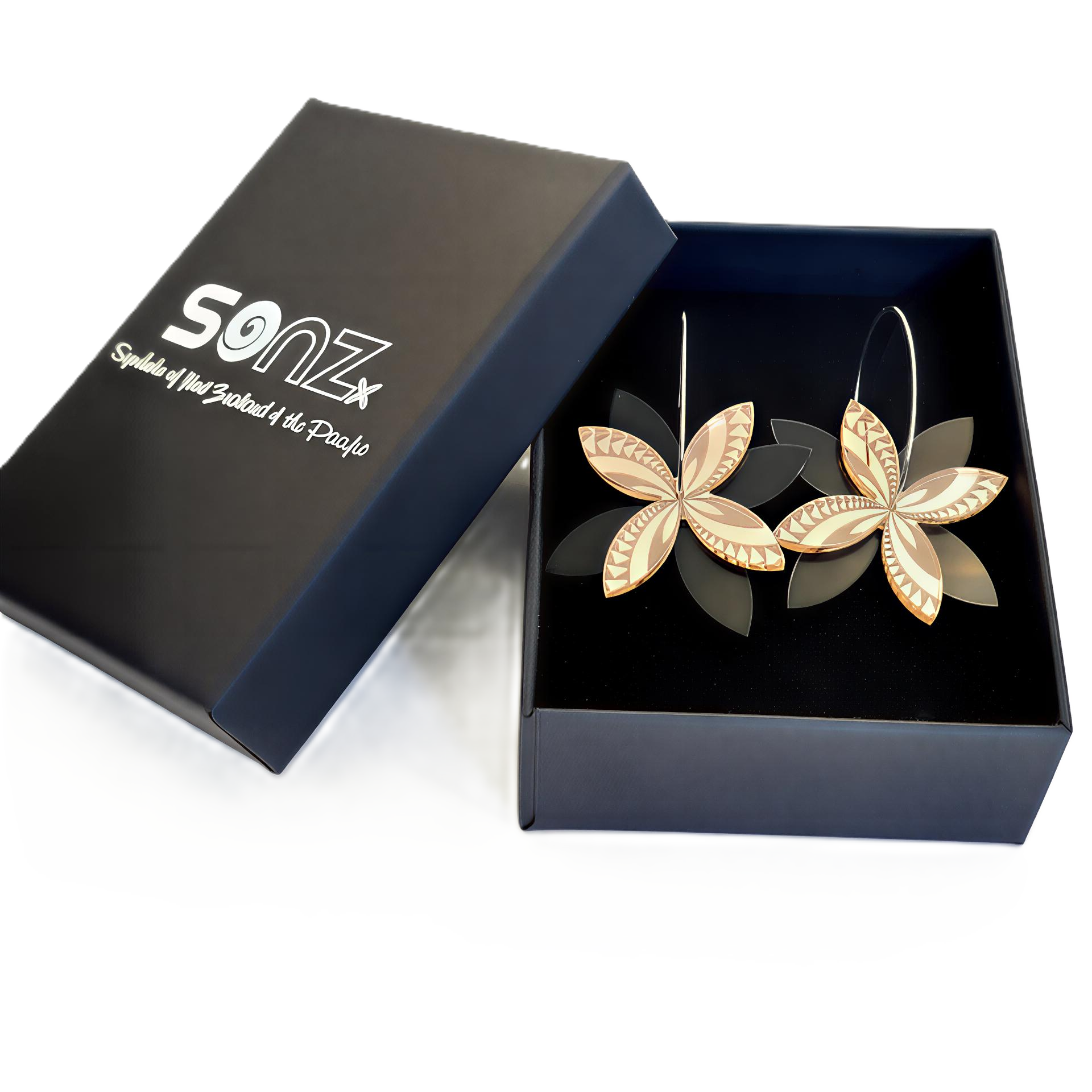 Frangipani Swirl Spinner earrings in SoNZ gift box; rose-gold mirror acrylic with black acrylic petals.