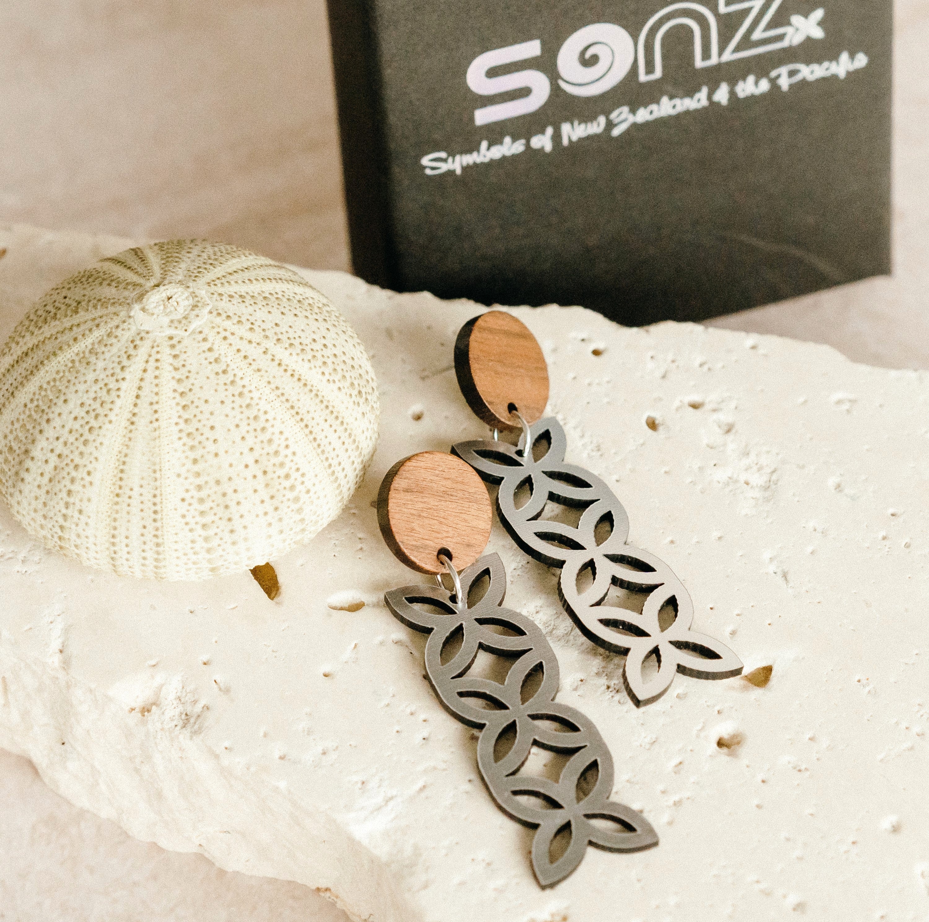 Frangipani Triple Wood Stud earrings on stone with SoNZ gift box; brushed silver metallic drops with natural wood studs.
