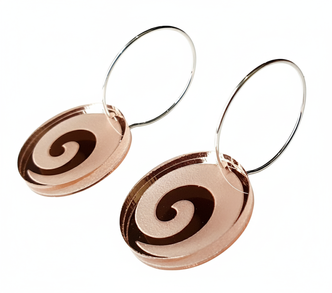 Koru Engraved hoop earrings, rose-gold mirror acrylic with engraved koru spiral, angled view.
