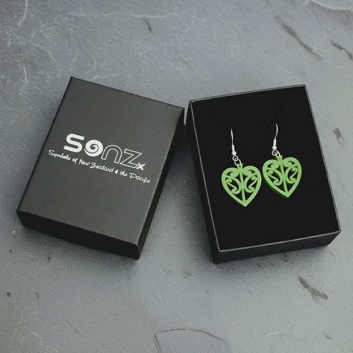Kōwhaiwhai Heart earrings in a black SoNZ gift box; pounamu satin open-heart with kōwhaiwhai cut-outs.