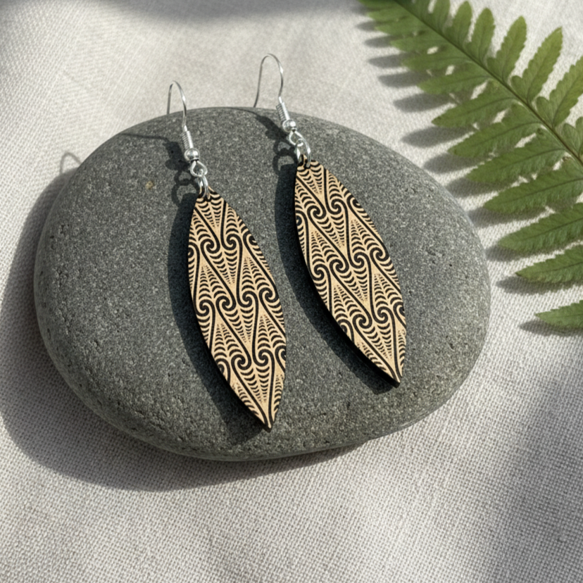 Kōwhaiwhai Shield earrings on stone with fern; brushed gold metallic pair.