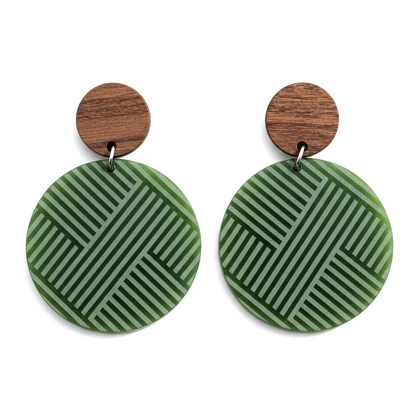 Mana Wood Stud earrings with natural wood studs above Pounamu Satin Acrylic discs engraved with a woven-line pattern.