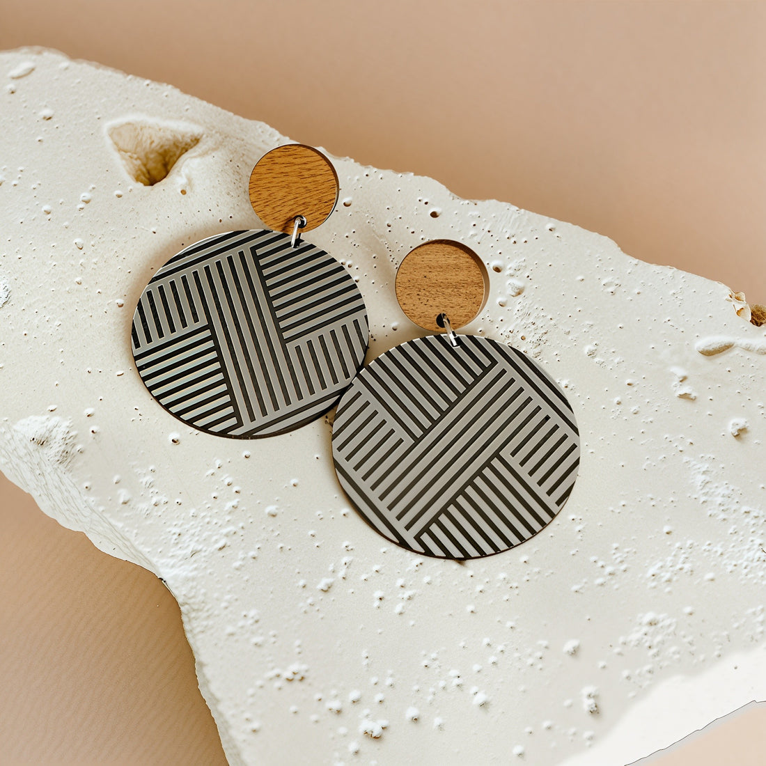 Mana Wood Stud earrings on light stone; brushed silver metallic rounds with natural wood studs.