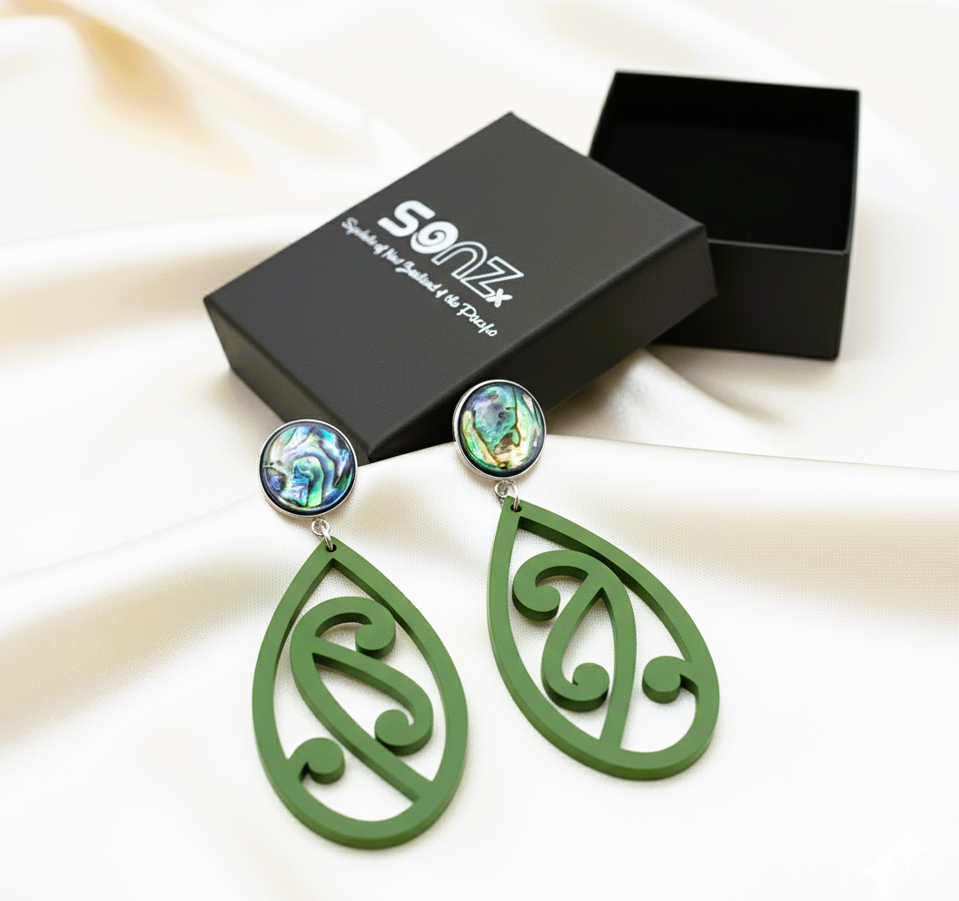 Pītau Pāua earrings in SoNZ gift box on silk; pounamu satin teardrops with pāua studs.