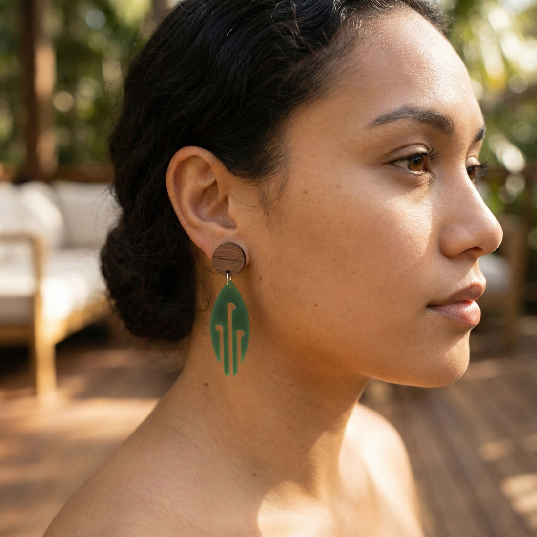 Model wearing Ponga Wood Stud earrings in Pounamu Satin Acrylic.