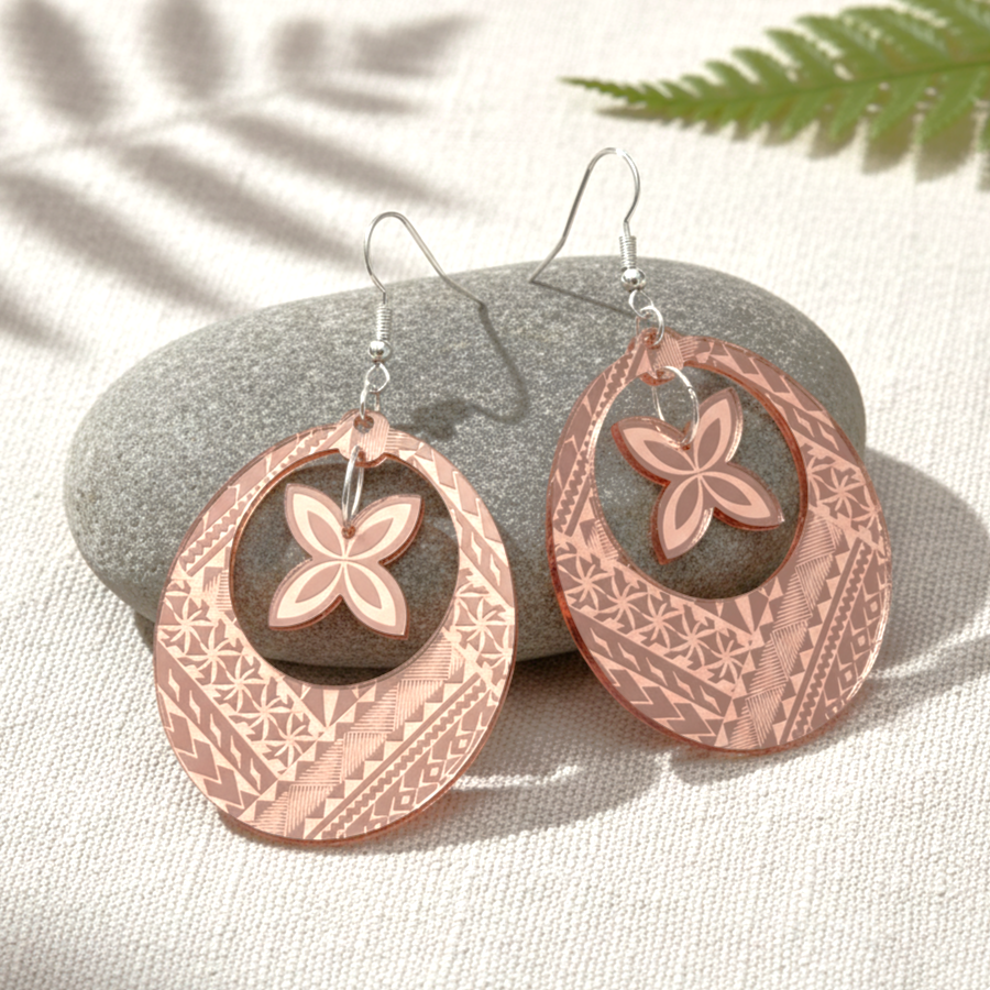 Samoan Hoop Frangi earrings on soft fabric with leaf shadow; rose-gold mirror pair and gold mirror pair.